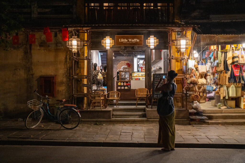 Guest exploring the lantern-lit streets of Hoi An Ancient Town just minutes from Hoi An Historic Hotel